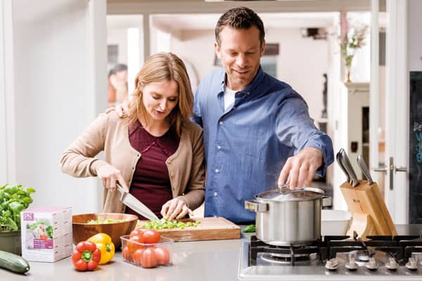 Two people making dinner